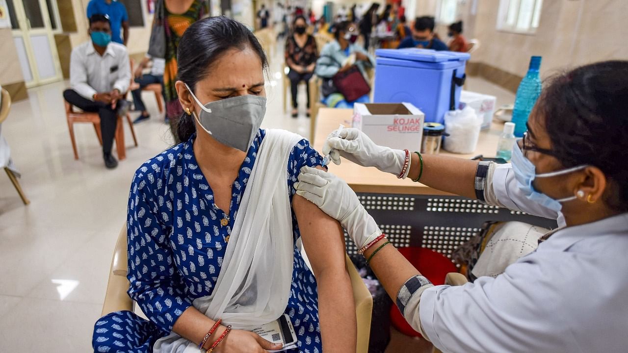 A health worker administers Covid-19 vaccine to a beneficiary in Prayagraj. Credit: PTI Photo
