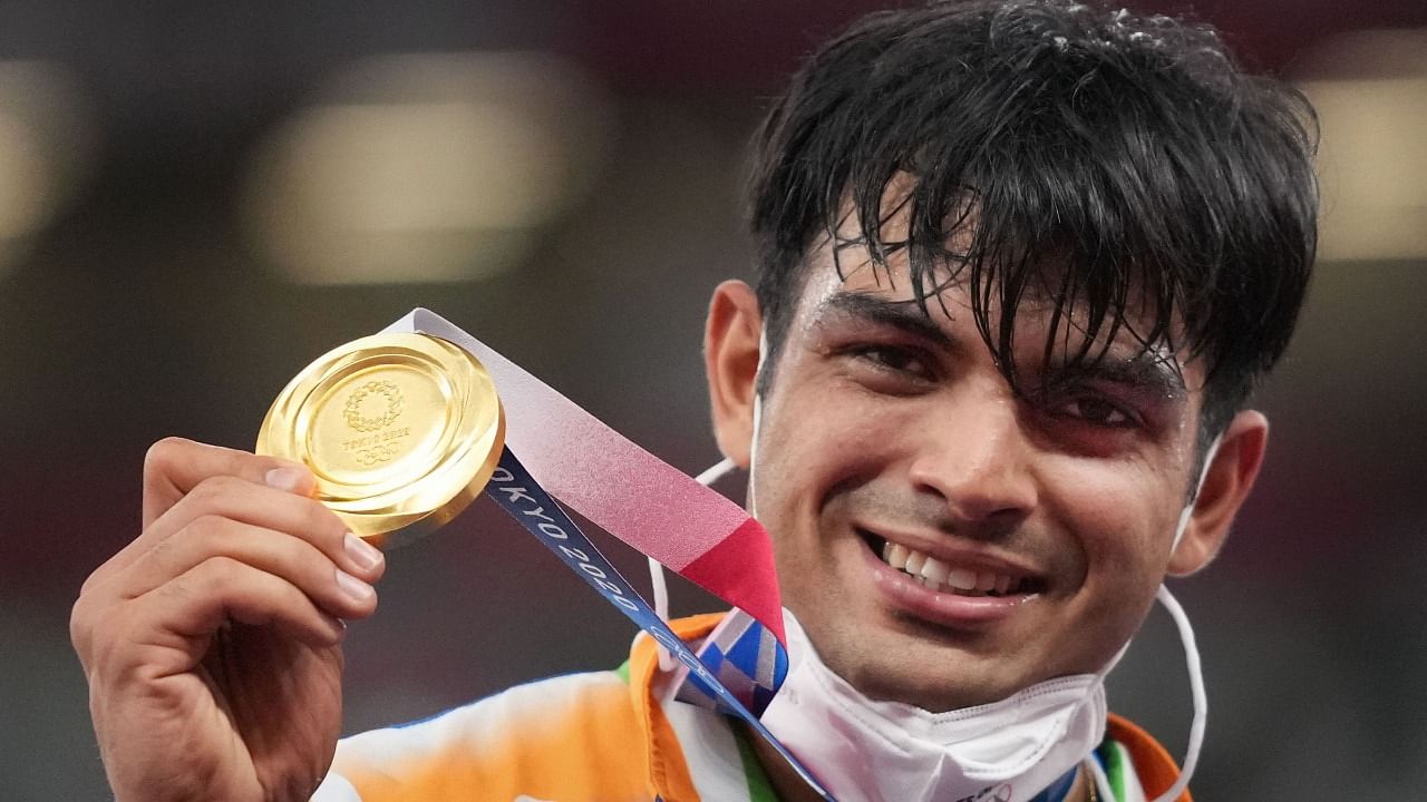 India's Neeraj Chopra holds the gold medal at the podium during the medal ceremony. Credit: PTI Photo