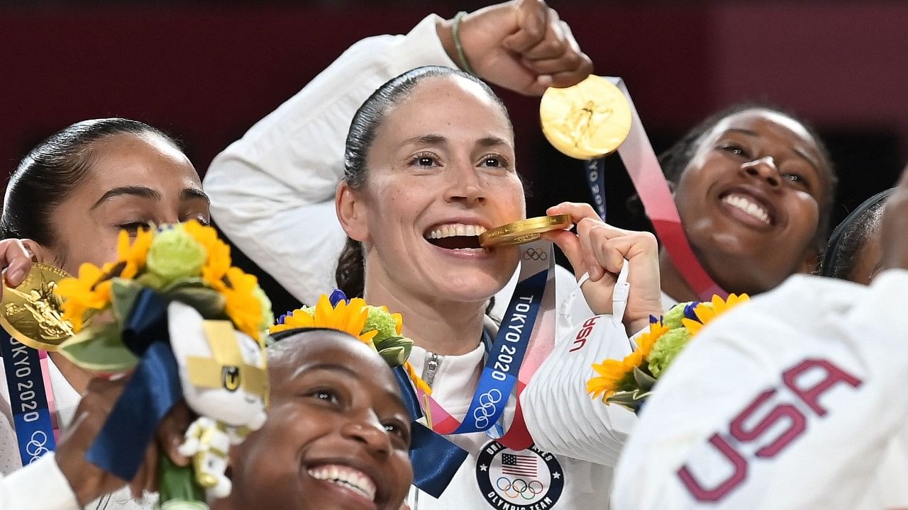 First placed USA's Sue Bird (C) celebrates with her gold medal and teammates. Credit: AFP Photo