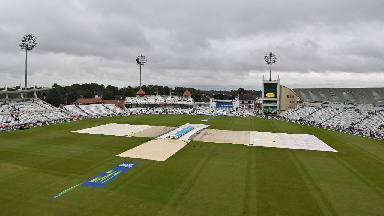 The covers remain on the pitch as rain delays the start of play on the day 5 of the first England-India Test at Trent Bridge cricket ground in Nottingham. Credit: AFP Photo