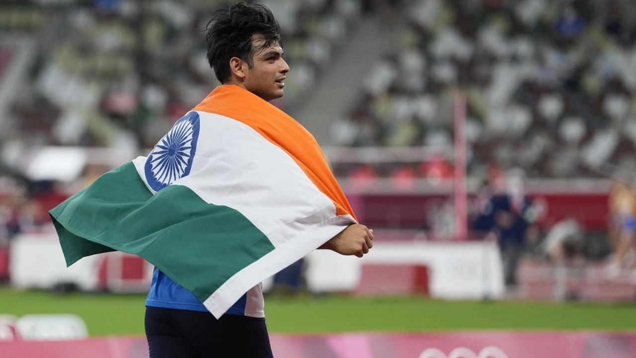 Neeraj Chopra, of India, celebrates after winning the men's javelin throw at the 2020 Summer Olympics. Credit: AP Photo