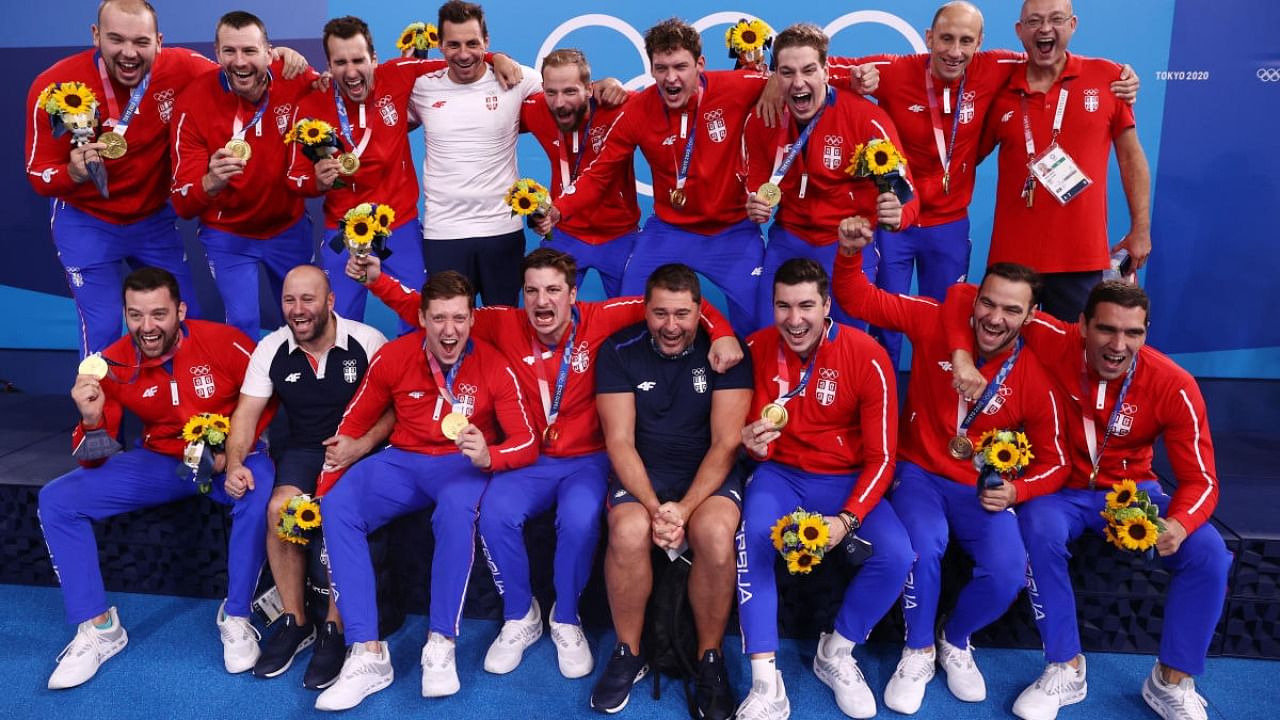 Gold medallists, Serbia's team members, pose for pictures and celebrate during medal ceremony. Credit: Reuters Photo