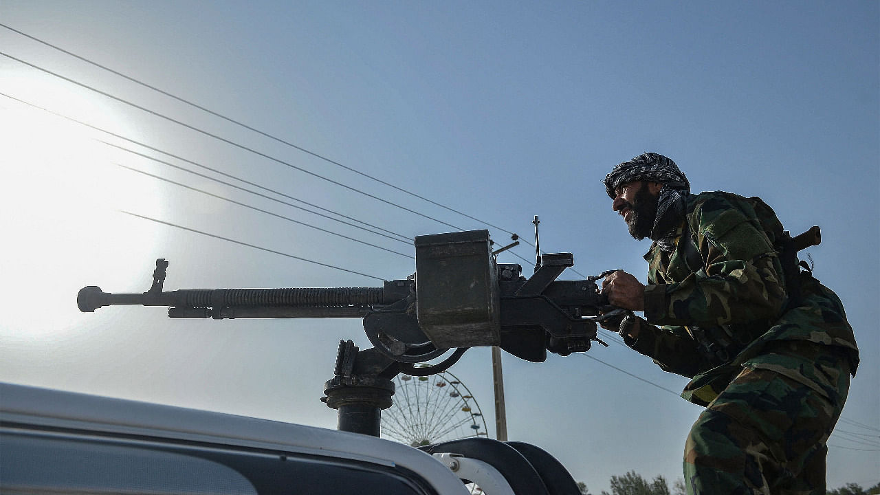 Afghan security personnel and Afghan militia fighting against Taliban, stand guard in Enjil district of Herat province. Credit: AFP Photo