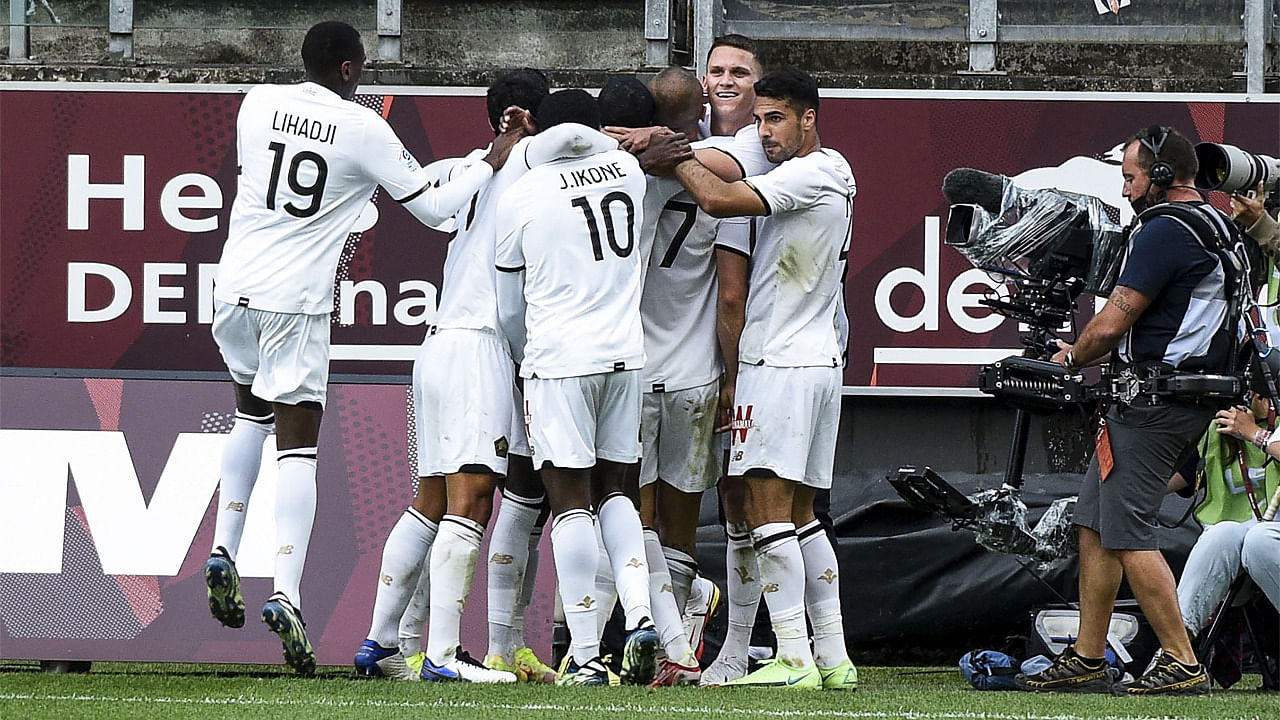 Lille's Turkish forward Burak Yilmaz (C) celebrates with teammates after scoring his team's third goal. Credit: AFP Photo