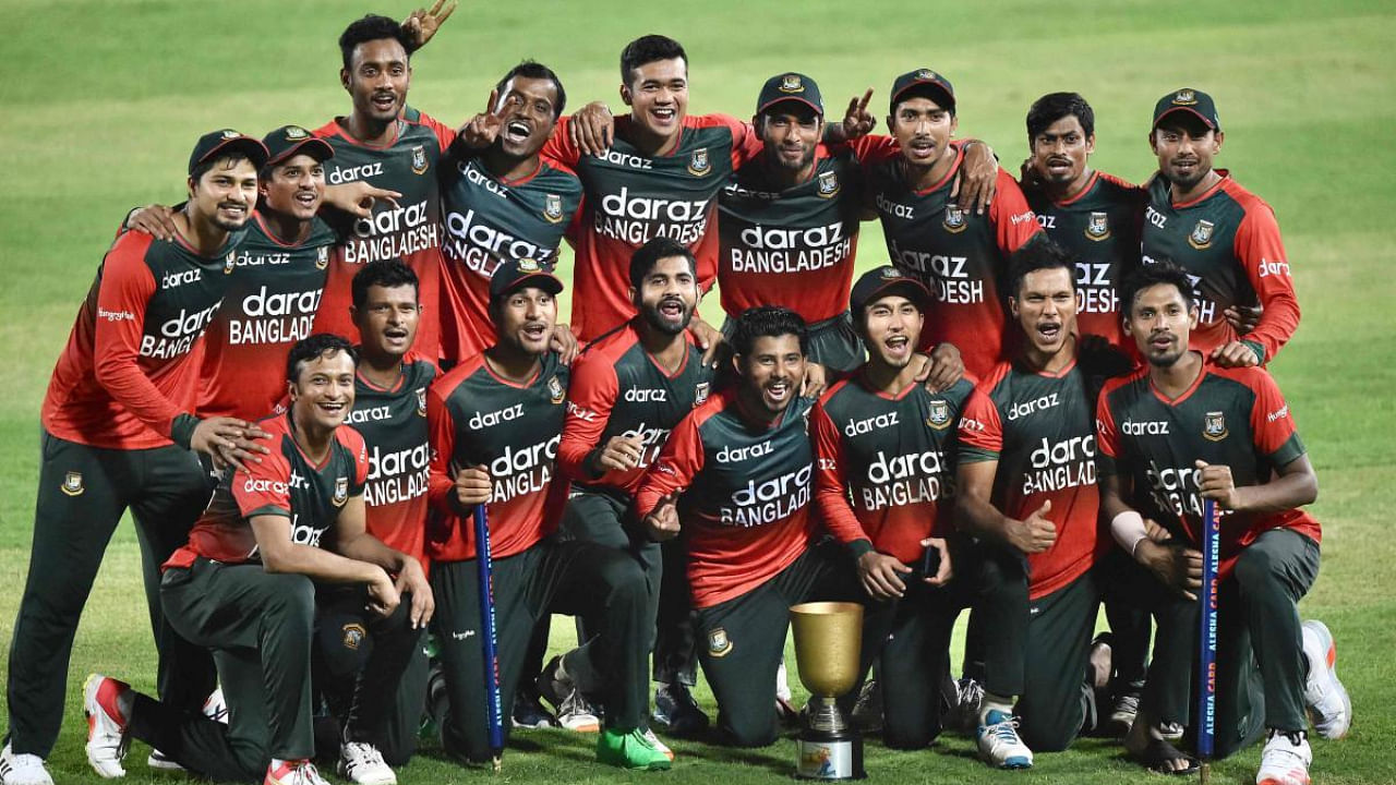 Bangladesh's cricketers pose for a picture after winning the fifth and final Twenty20 international cricket match between Bangladesh and Australia at the Sher-e-Bangla National Cricket Stadium in Dhaka on August 9, 2021. Credit: AFP Photo