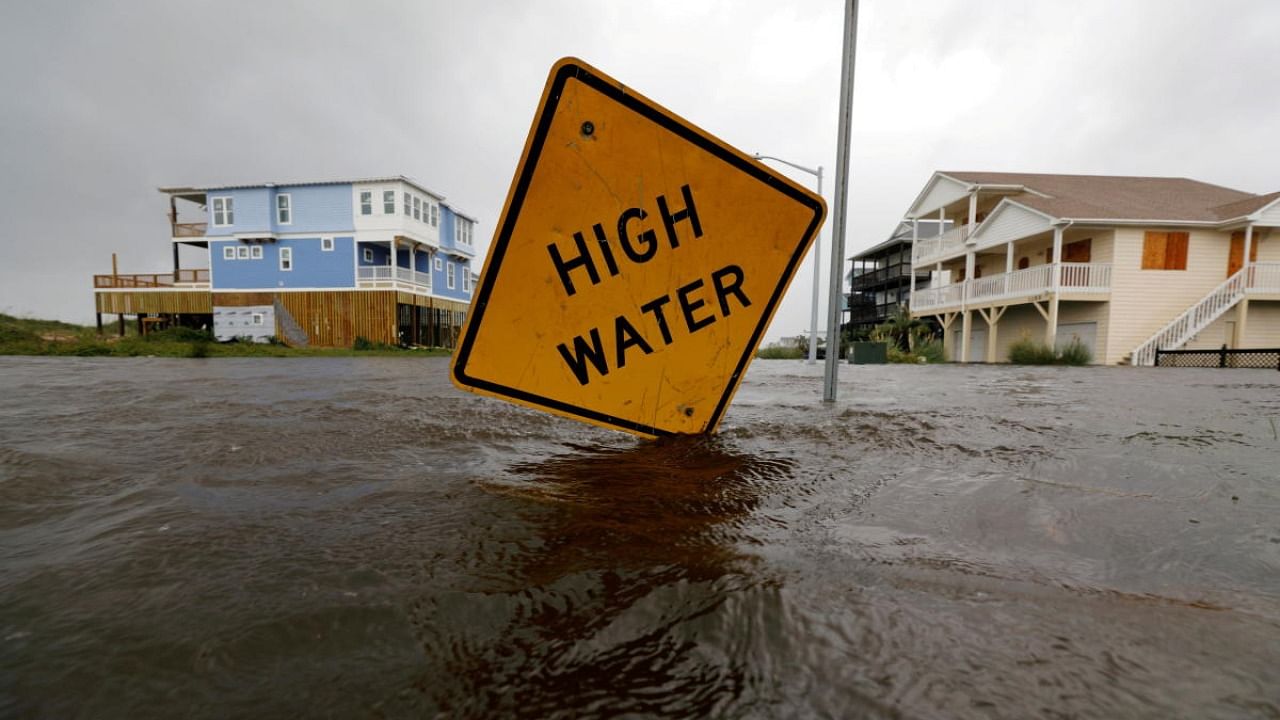 Flood waters lap at a high water warning sign that was partially pushed over by Hurricane Florence on Oak Island, North Carolina. Credit: Reuters File Photo