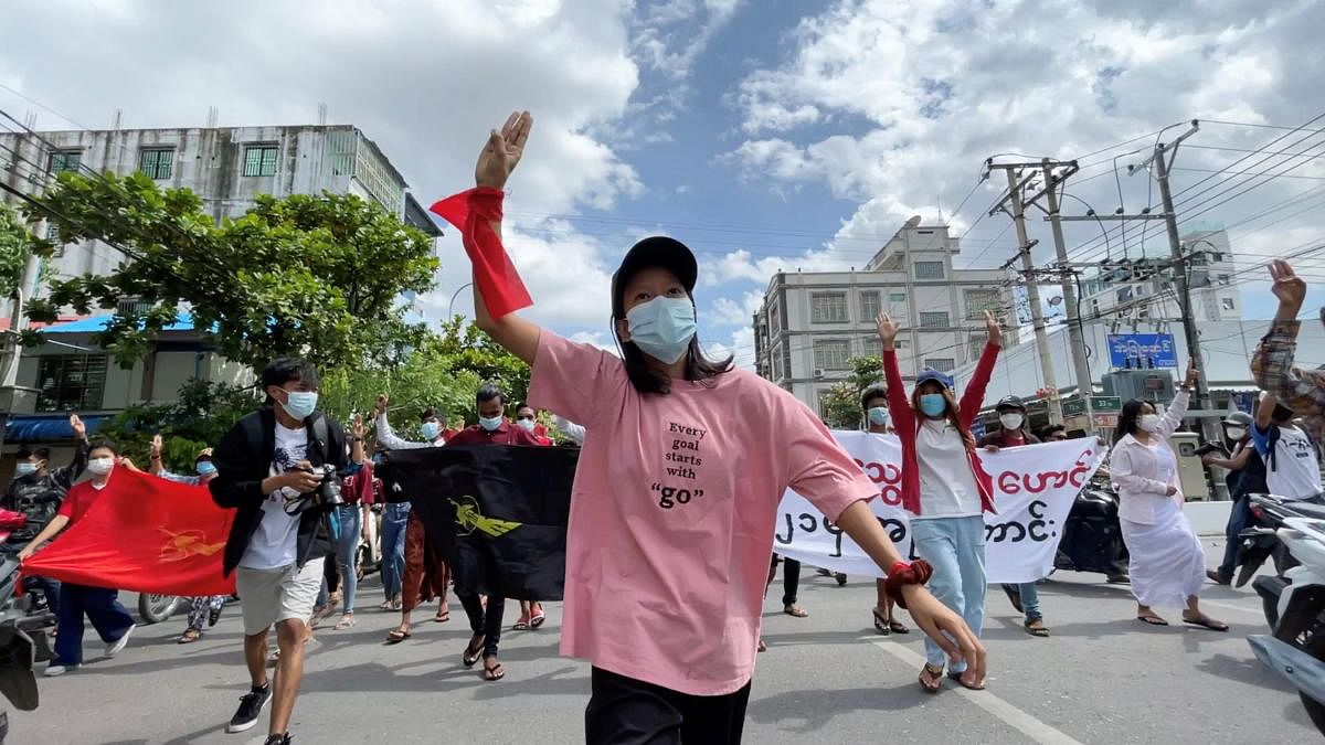An anti-coup protester shows the three-finger salute during a march on the anniversary of a 1988 uprising, in Mandalay, Myanmar. Credit: Reuters Photo