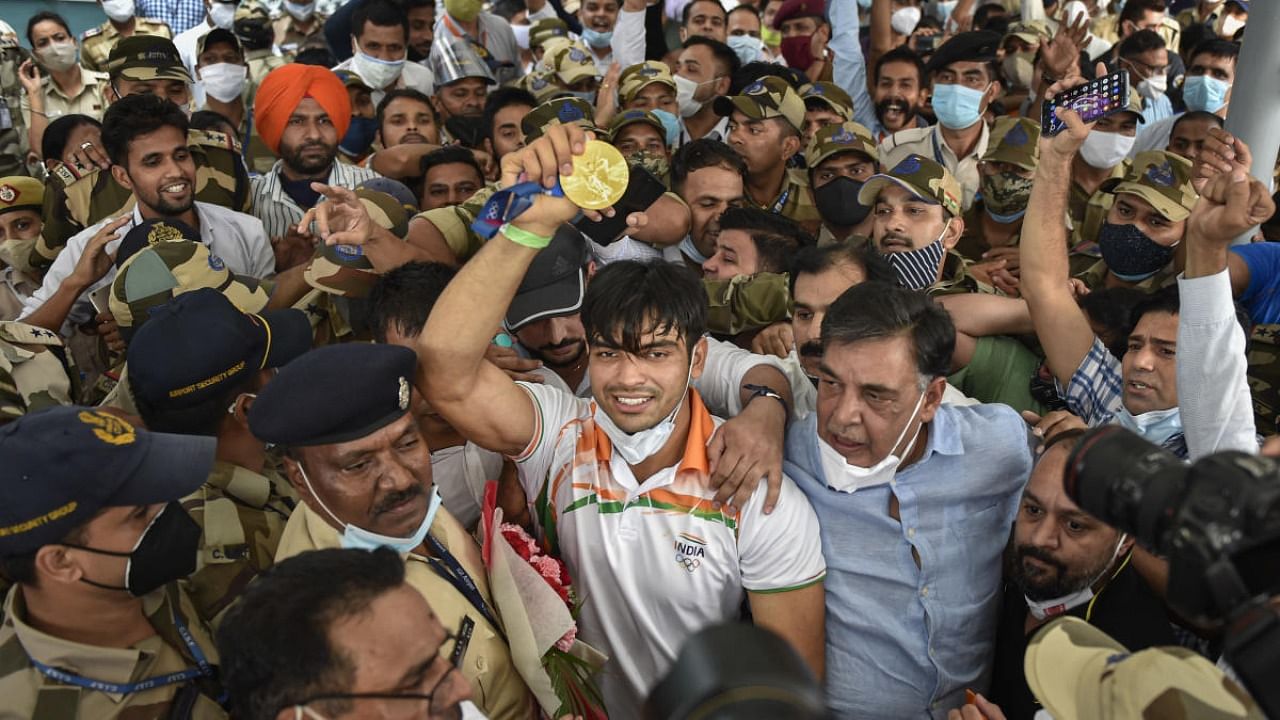 Olympic gold medalist Neeraj Chopra being welcomed on his arrival at IGI Airport, after the end of the Tokyo Summer Olympics 2020, in New Delhi. Credit: PTI Photo