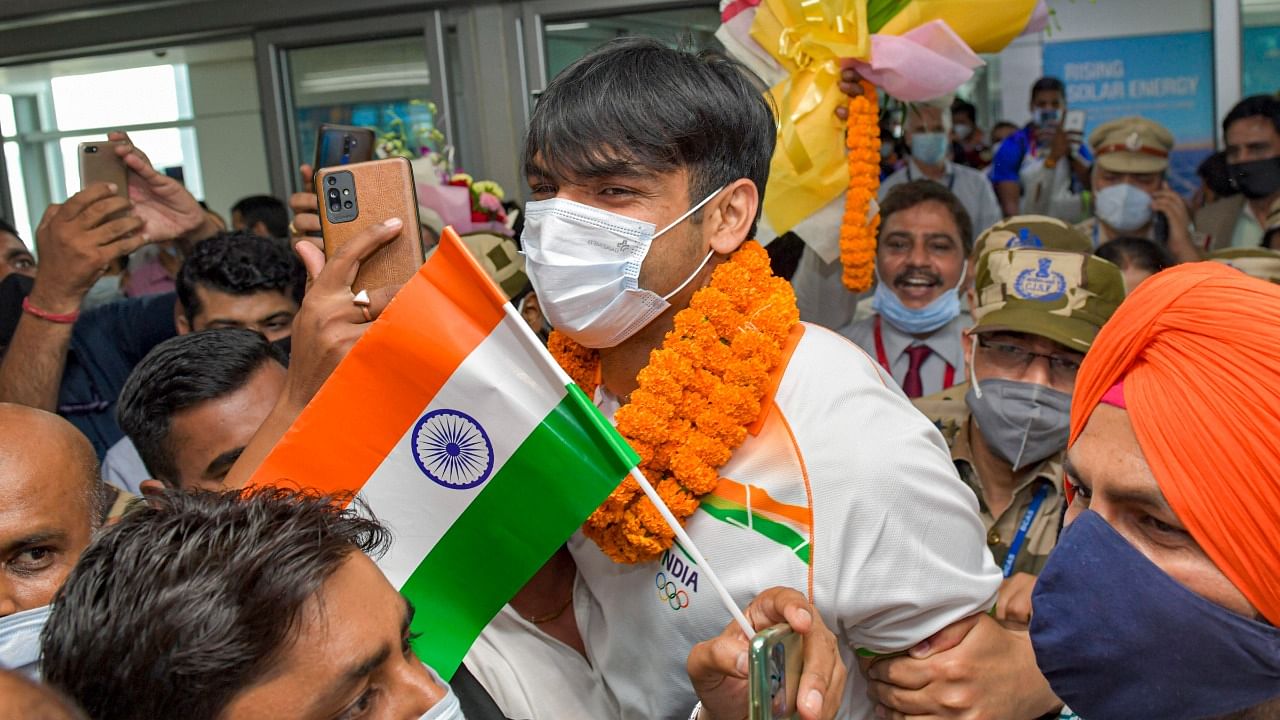 Olympic gold medalist Neeraj Chopra being welcomed on his arrival at IGI Airport, New Delhi. Credit: PTI Photo