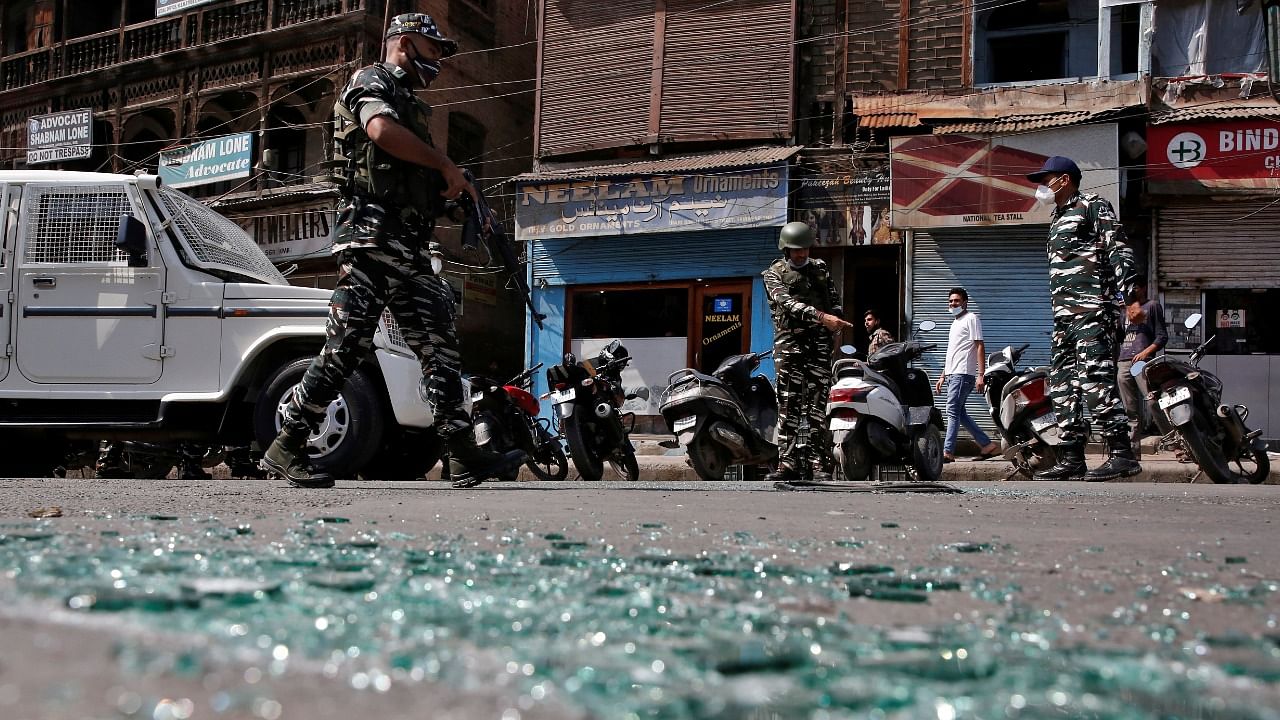 CRPF personnel examine the site of a grenade explosion in Srinagar. Credit: Reuters Photo