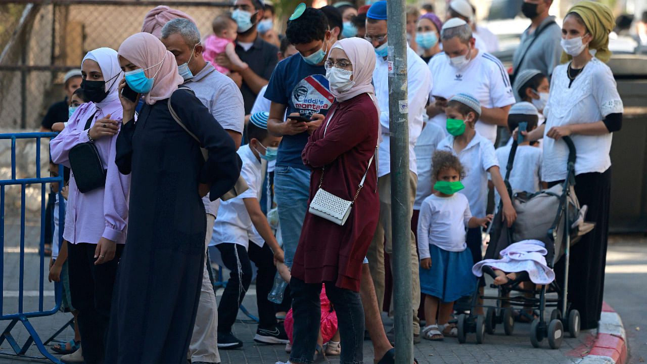 Muslims and Jews wait outside Israel's Magen David Adom medical service for a rapid Covid-19 antigenic test in Jerusalem. Credit: AFP Photo