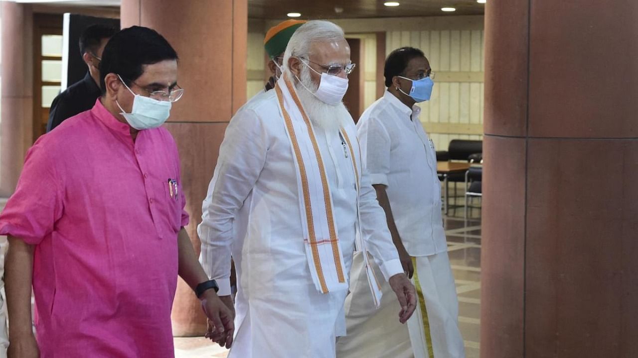 Prime Minister Narendra Modi with Parliamentary Affairs Minister Pralhad Joshi arrives for the BJP Parliamentary Party meeting, during the Monsoon Session of Parliament, in New Delhi, Tuesday, August 10, 2021. Credit: PTI Photo