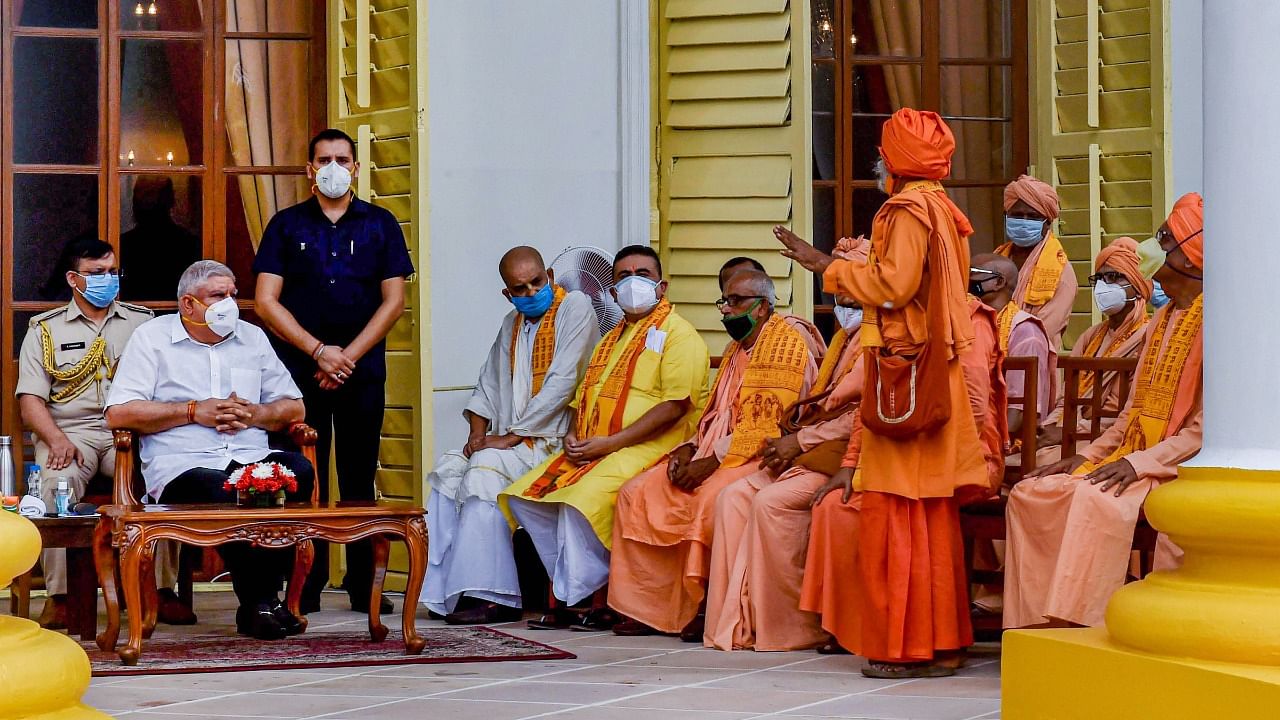  Opposition leader Suvendu Adhikari, accompanied by monks, meets with Governor Jagdeep Dhankhar at Raj Bhavan, in Kolkata. Credit: PTI Photo