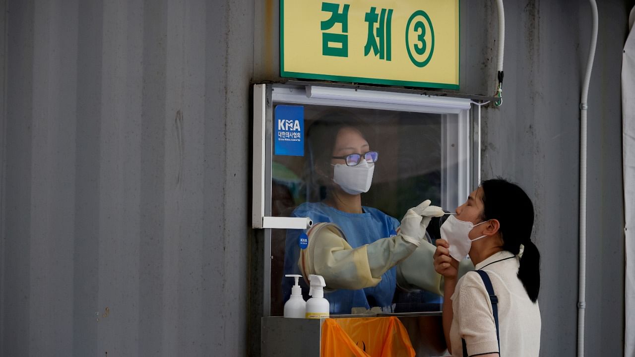 A woman gets a Covid test in Seoul. Credit: Reuters Photo