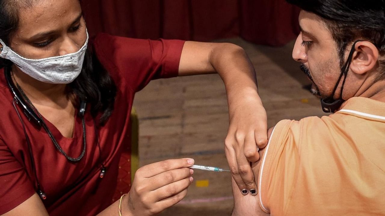 A health worker inoculates a man with the dose of Covaxin vaccine against the Covid-19 coronavirus during a vaccination camp held in Ahmedabad on August 8, 2021. Credit: AFP Photo