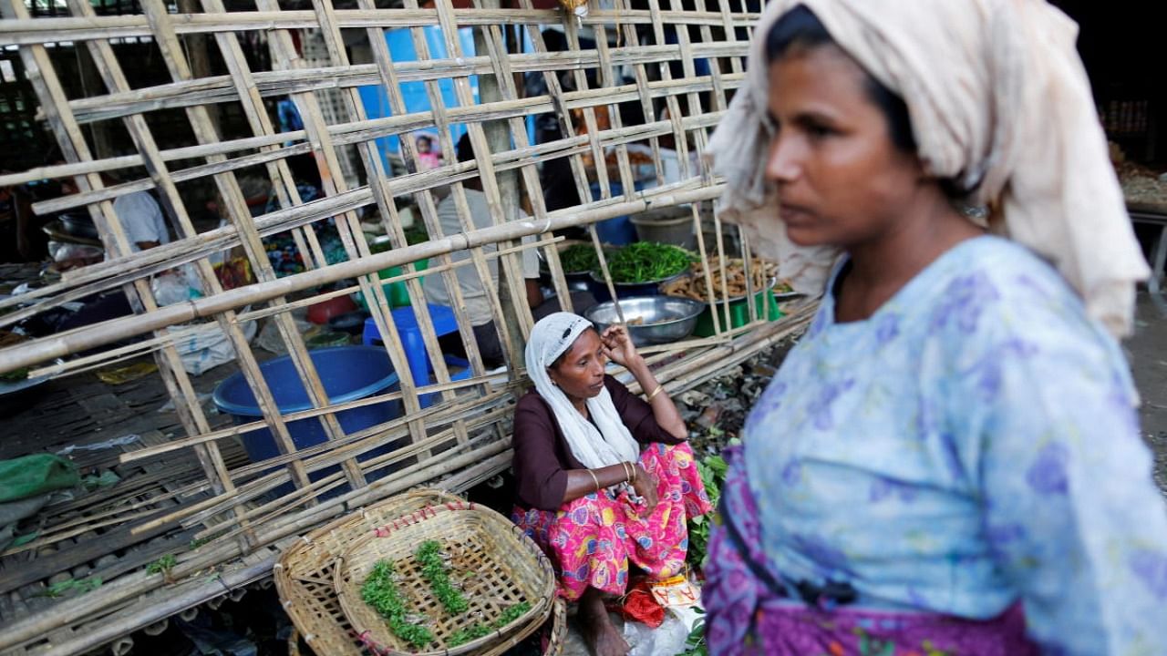 A woman sells food at the internally displaced persons camp for Rohingya people outside Sittwe in the state of Rakhine. Credit: Reuters File Photo