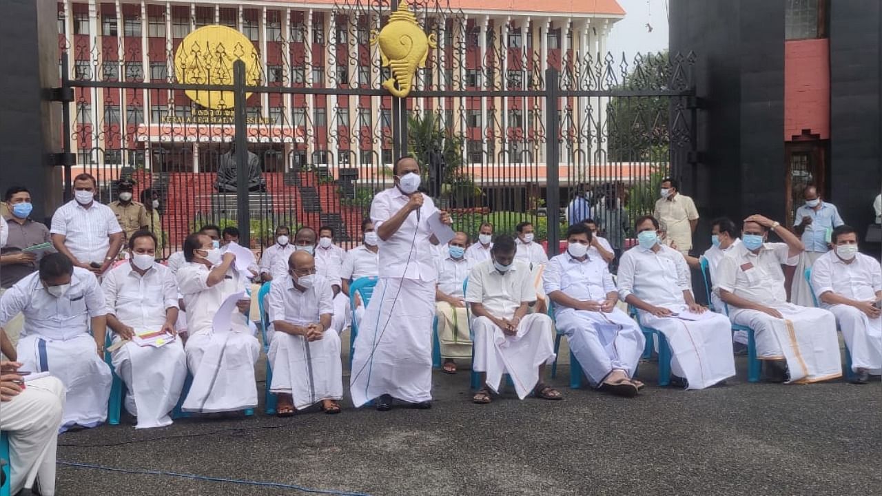 The Opposition MLAs, led by Opposition leader V D Satheesan, walked out of the House and staged a mock Assembly in front of the Assembly gate. Credit: Special Arrangement. 