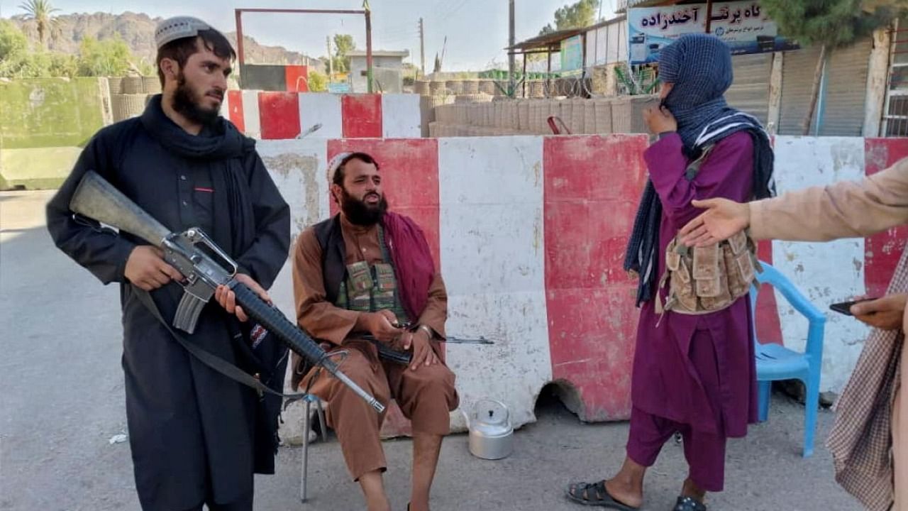 Taliban fighters stand guard at a check point in Farah, Afghanistan. Credit: Reuters Photo