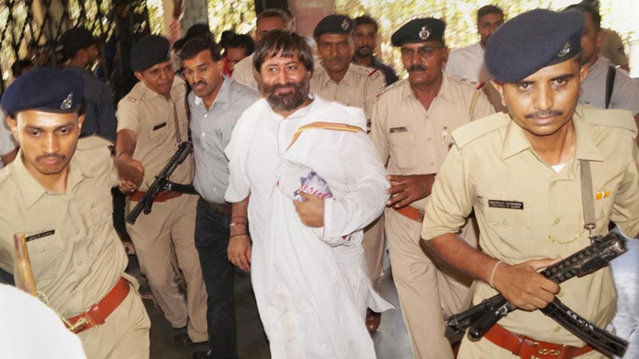 Police escort Asaram's son Narayan Sai for treatment to a hospital in Surat on Saturday. Credit: PTI File Photo