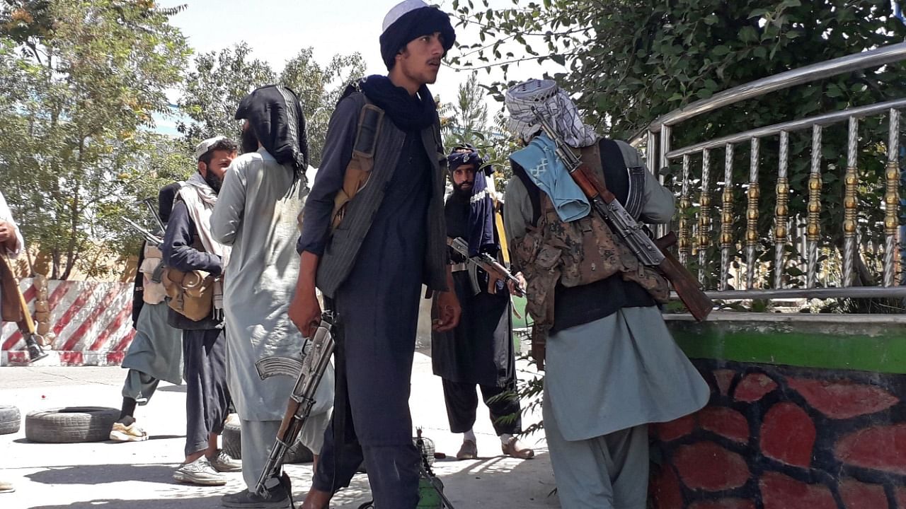 Taliban fighters stand along the roadside in Ghazni on August 12, 2021, as Taliban move closer to Afghan capital after taking Ghazni city. Credit: AFP Photo