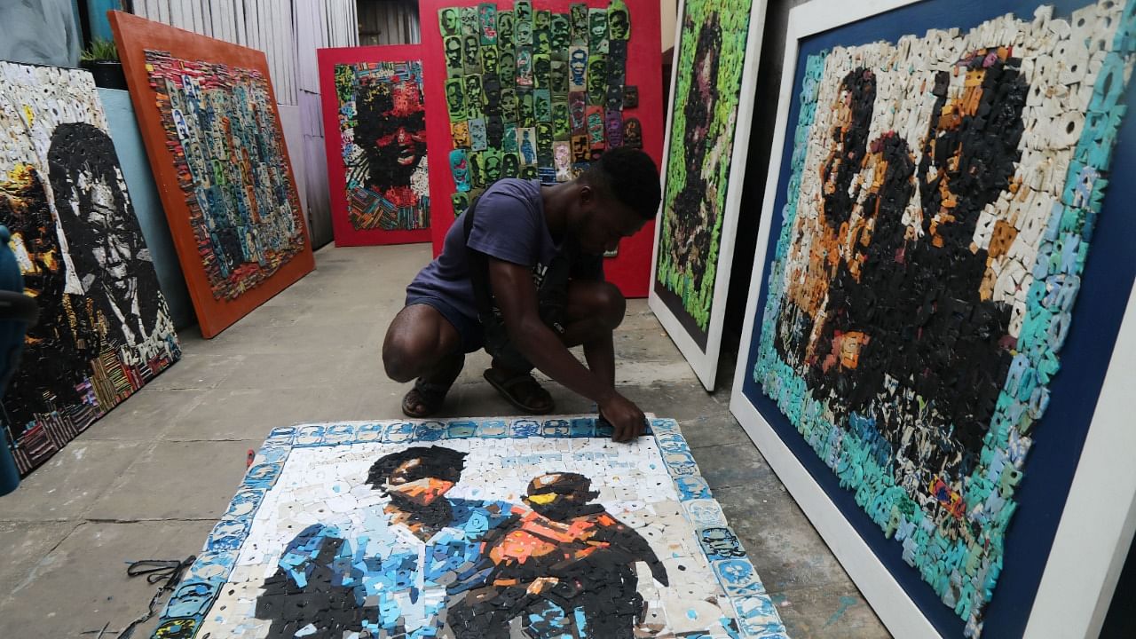 Ivorian painter Aristide Kouame 26, who paints optical effects artworks with worn soles. Credit: Reuters Photo