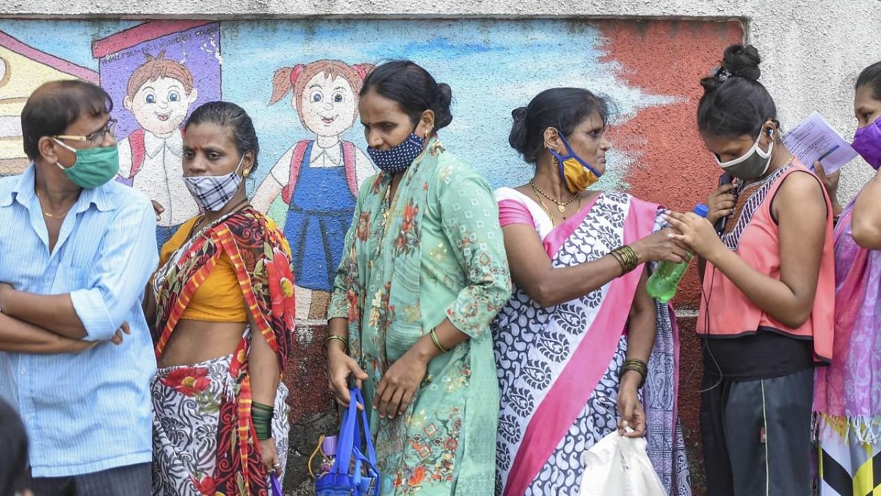 Beneficiaries wait in a queue to receive Covid-19 vaccine dose, at a vaccination centre in Mumbai. Credit: PTI Photo
