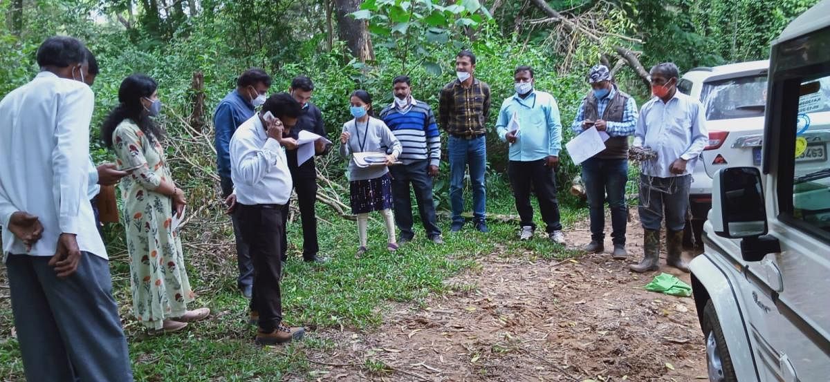 Tahsildar Govindraj and Taluk Panchayat EO Jayanna survey the land for the proposed solid waste management unit in Byadagotta Gram Panchayat limits.