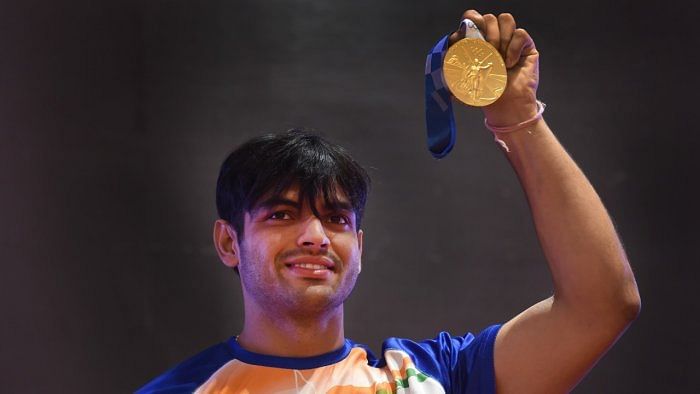 Javelin thrower Neeraj Chopra poses with his Olympic gold medal. Credit: PTI Photo