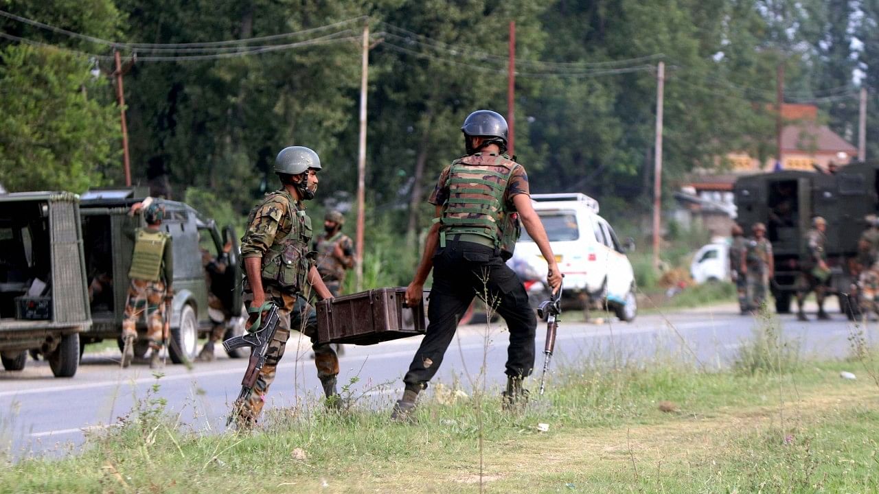 Security personnel during an encounter with militants after they opened fire at a BSF convoy, in Kulgam. Credit: PTI Photo