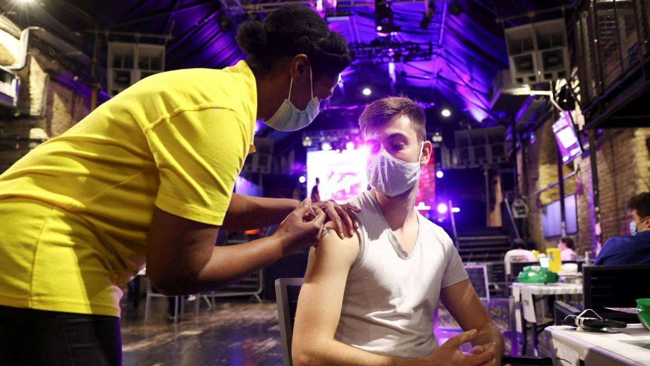 A person receives a dose of the Pfizer BioNTech vaccine at an NHS vaccination centre hosted at the Heaven nightclub in London. Credit: Reuters photo