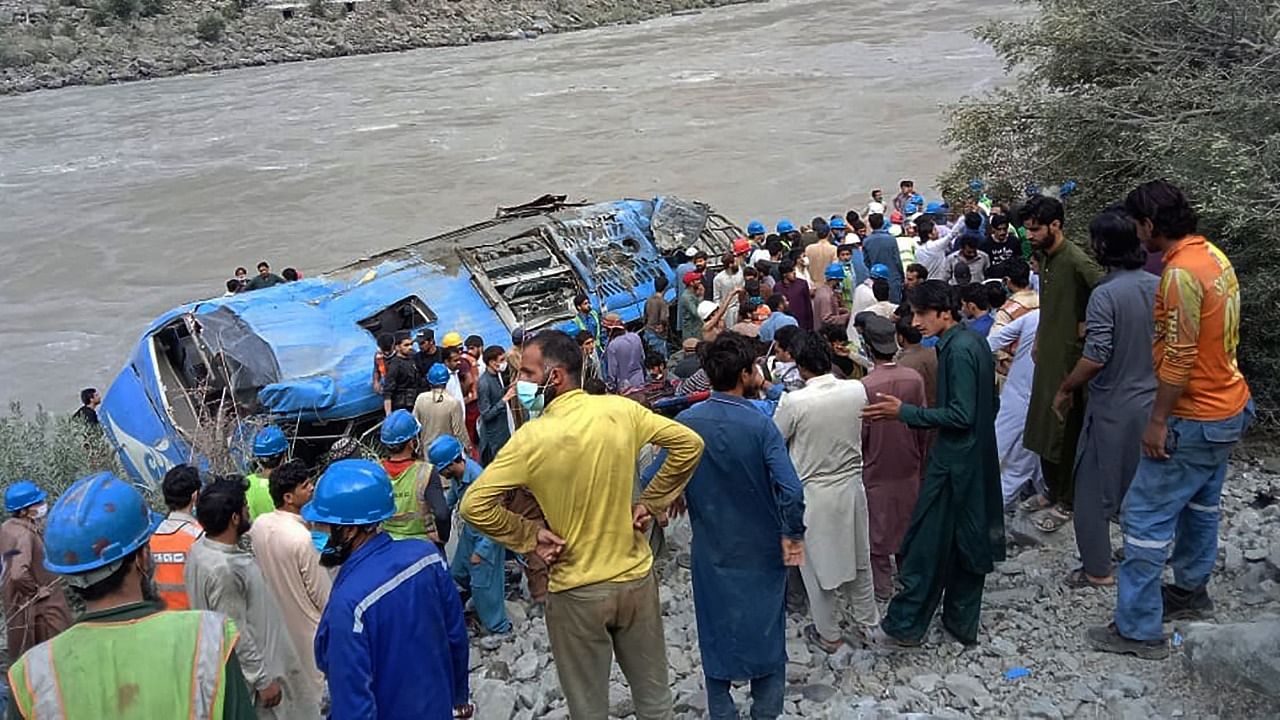 Local residents and rescue workers gather at the site of bus accident, in Kohistan Kohistan district of Pakistan's Khyber Pakhtunkhwa province. Credit: AFP Photo