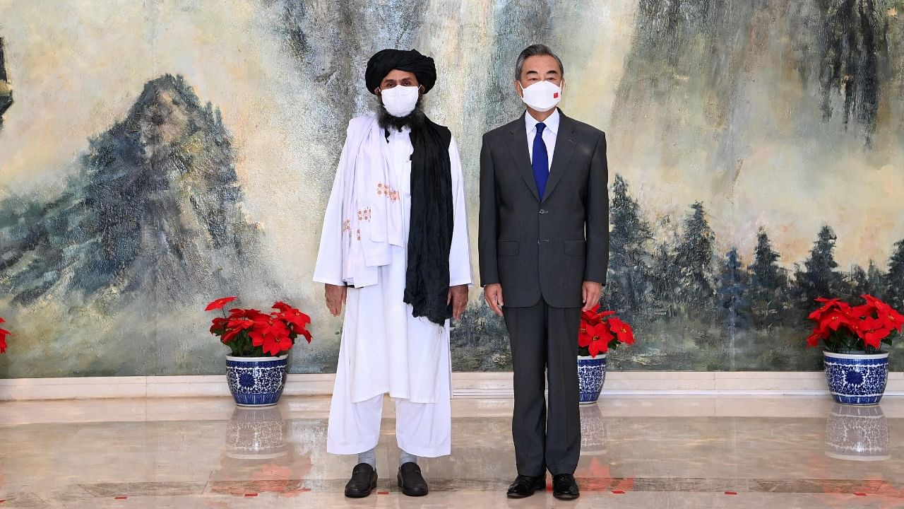 China Foreign Minister Wang Yi (R) meeting with Mullah Abdul Ghani Baradar of the Taliban. Credit: AFP Photo