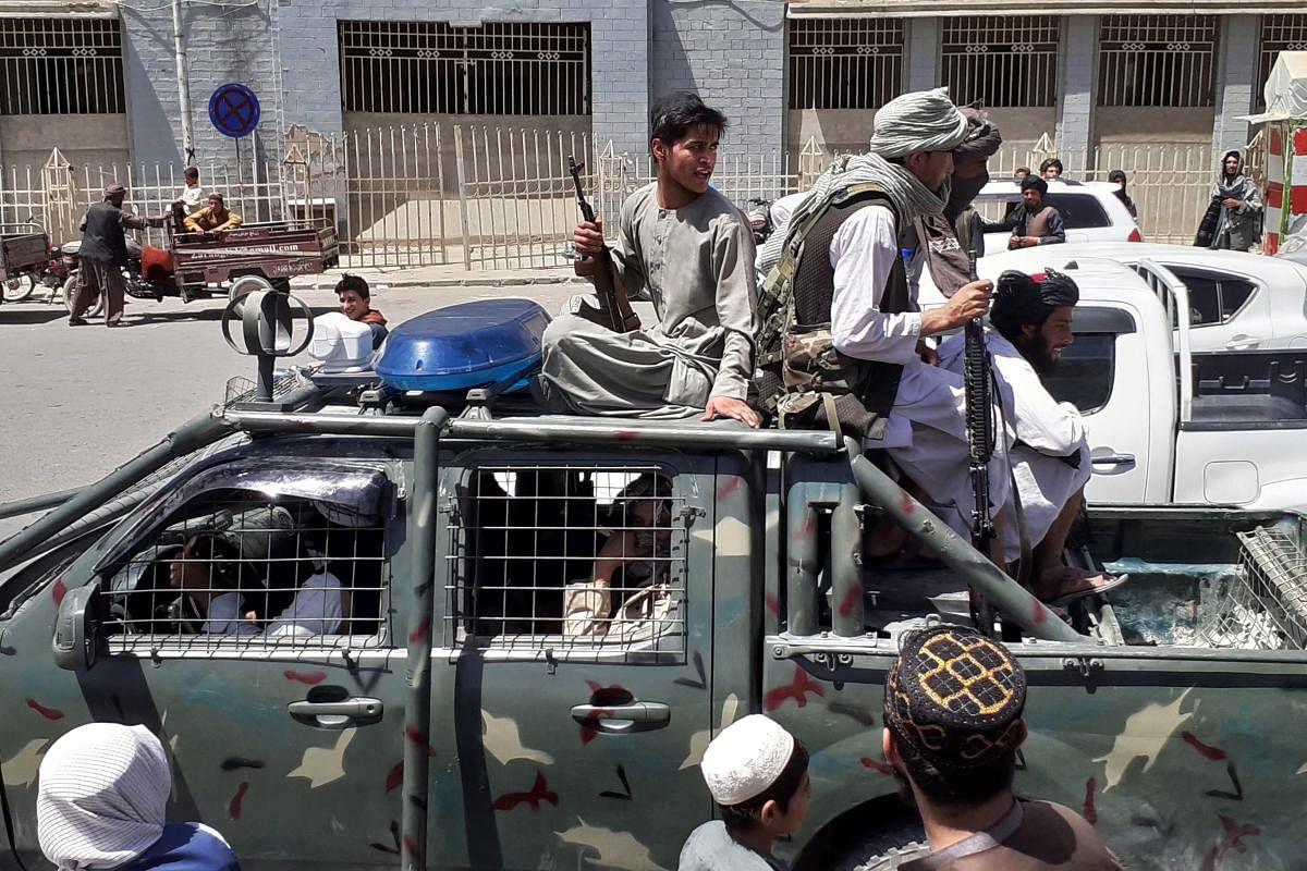 Taliban fighters are pictured in a vehicle of Afghan National Directorate of Security (NDS) on a street in Kandahar on August 13, 2021. Credit: AFP Photo