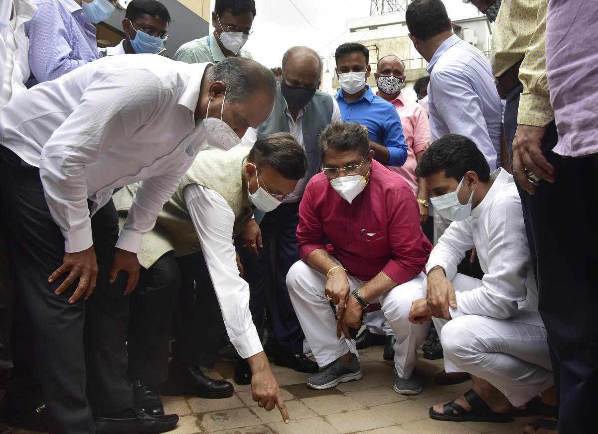 Revenue Minister R Ashoka along with MP P C Mohan, MLA Rizwan Arshad, BBMP Chief Commissioner Gaurav Gupta and other officials inspect the quality of the road tiles used at Commercial Street. Credit: DH Photo/Prashanth H G