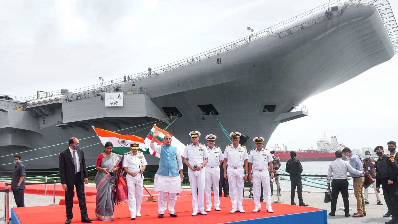 Defence Minister Rajnath Singh waves during a visit to the INS Vikrant. Credit: PTI File Photo
