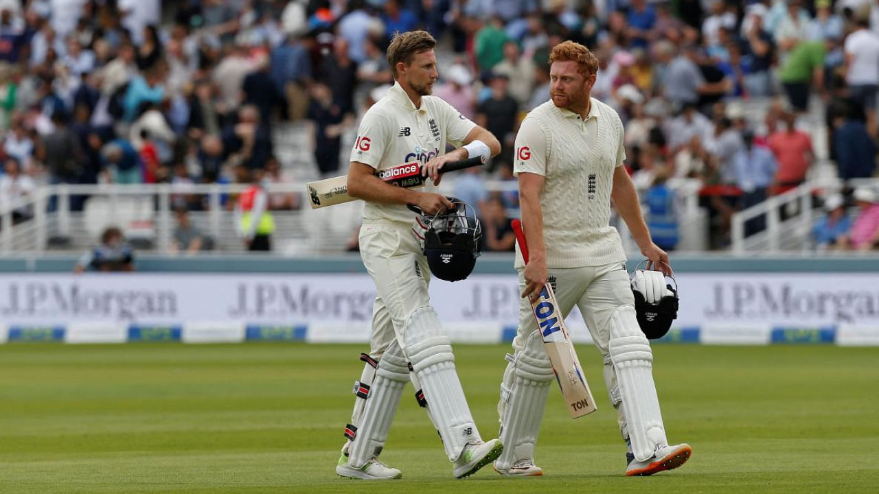 England's captain Joe Root (L) and England's Jonny Bairstow leave the pitch for lunch on the third day of the second cricket Test match between England and India at Lord's cricket ground in London. Credit: AFP Photo