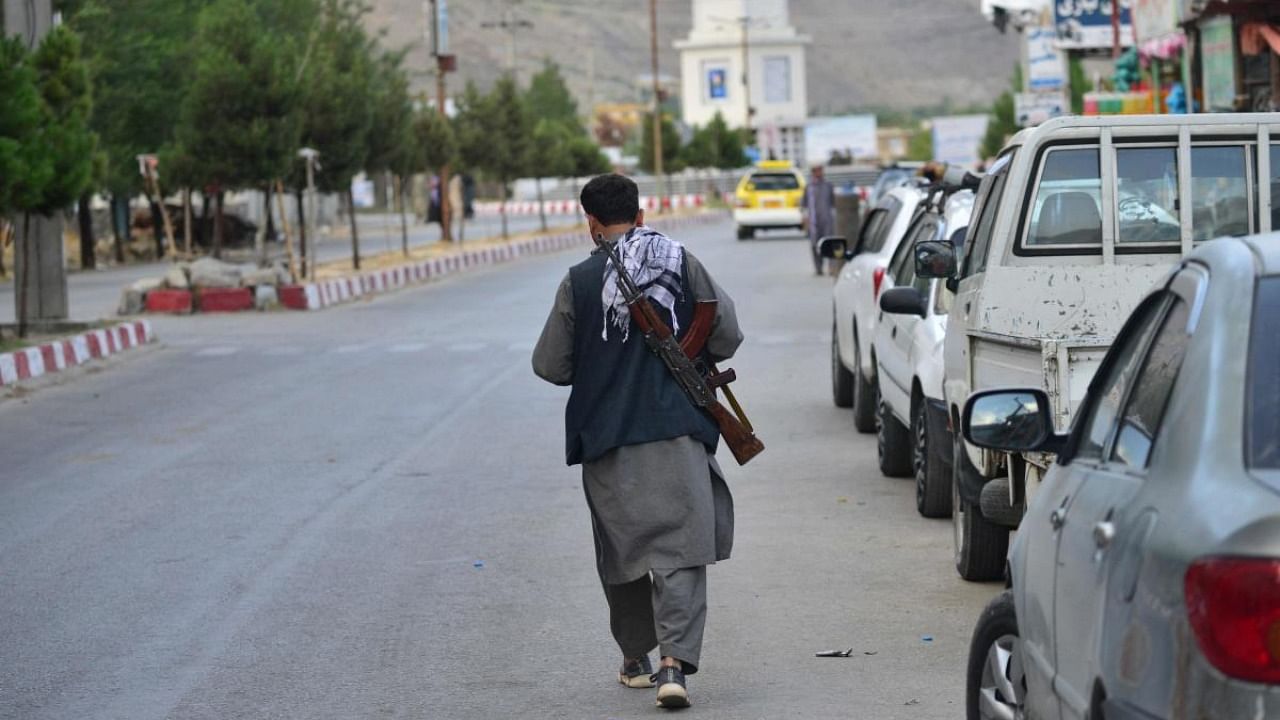 A member of Afghan security force walks through a road in Panjshir province. Credit: AFP Photo