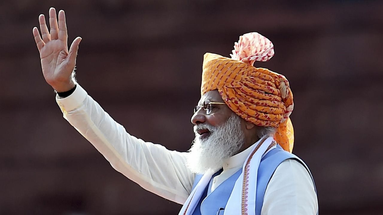 Prime Minister Narendra Modi waves at the audience during the 75th Independence Day function at the historic Red Fort, in New Delhi. Credit: PTI Photo