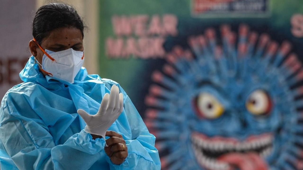 Health workers wear personal protective equipment (PPE) as they prepare to perform Covid-19 coronavirus screening at a railway station in Chennai on August 5, 2021. Credit: AFP Photo