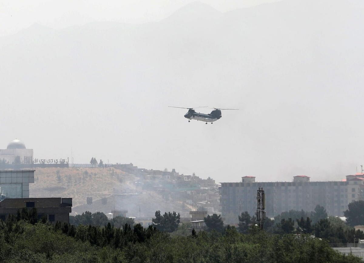 Helicopters fly over Kabul evacuating personnel. Credit: Reuters Photo