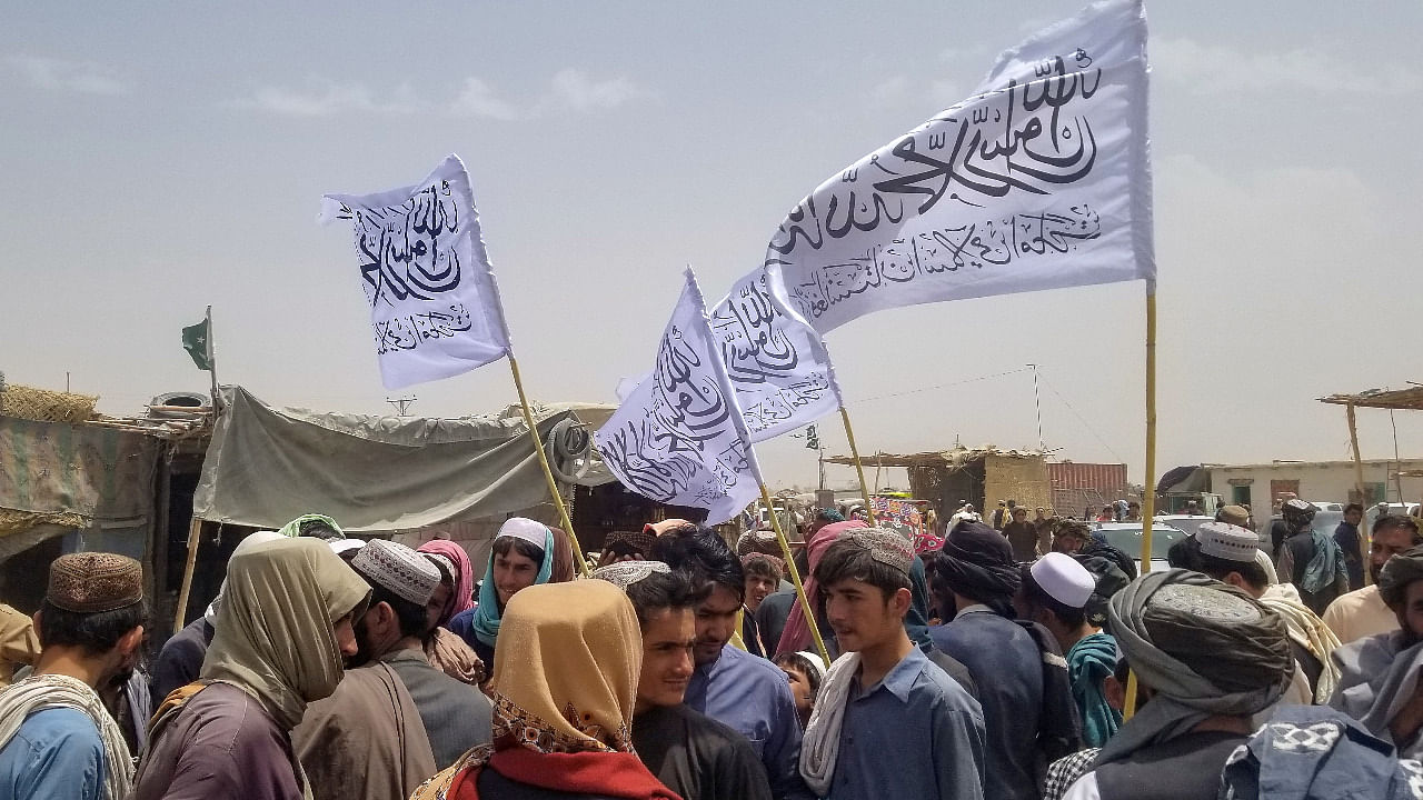 People with Taliban's flags gather to welcome a man (not pictured) who was released from prison in Afghanistan. Credit: Reuters Photo