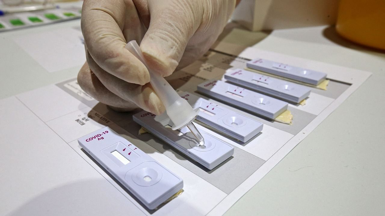 A healthcare workers prepares Rapid antigen test (RAT) kits. Credit: AFP Photo