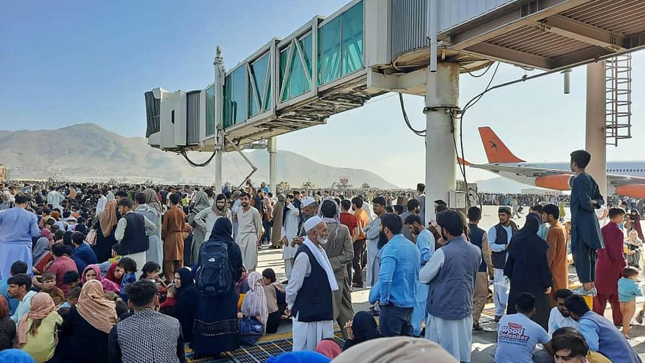 Afghans crowd at the tarmac of the Kabul airport on August 16, 2021, to flee the country as the Taliban were in control of Afghanistan after President Ashraf Ghani fled the country and conceded the insurgents had won the 20-year war. Credit: AFP Photo