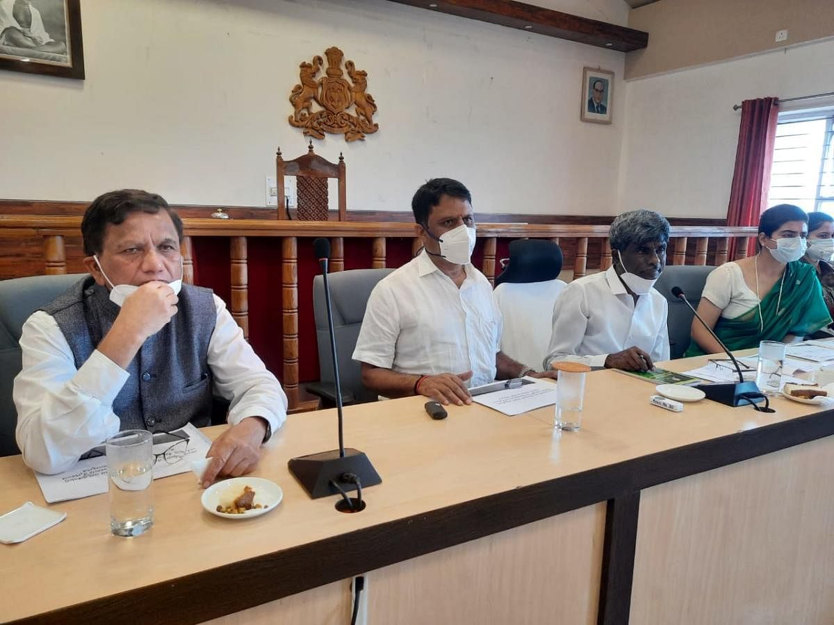 District In-charge Minister Kota Srinivas Poojary conducts a meeting at the DC's office in Madikeri on Sunday.