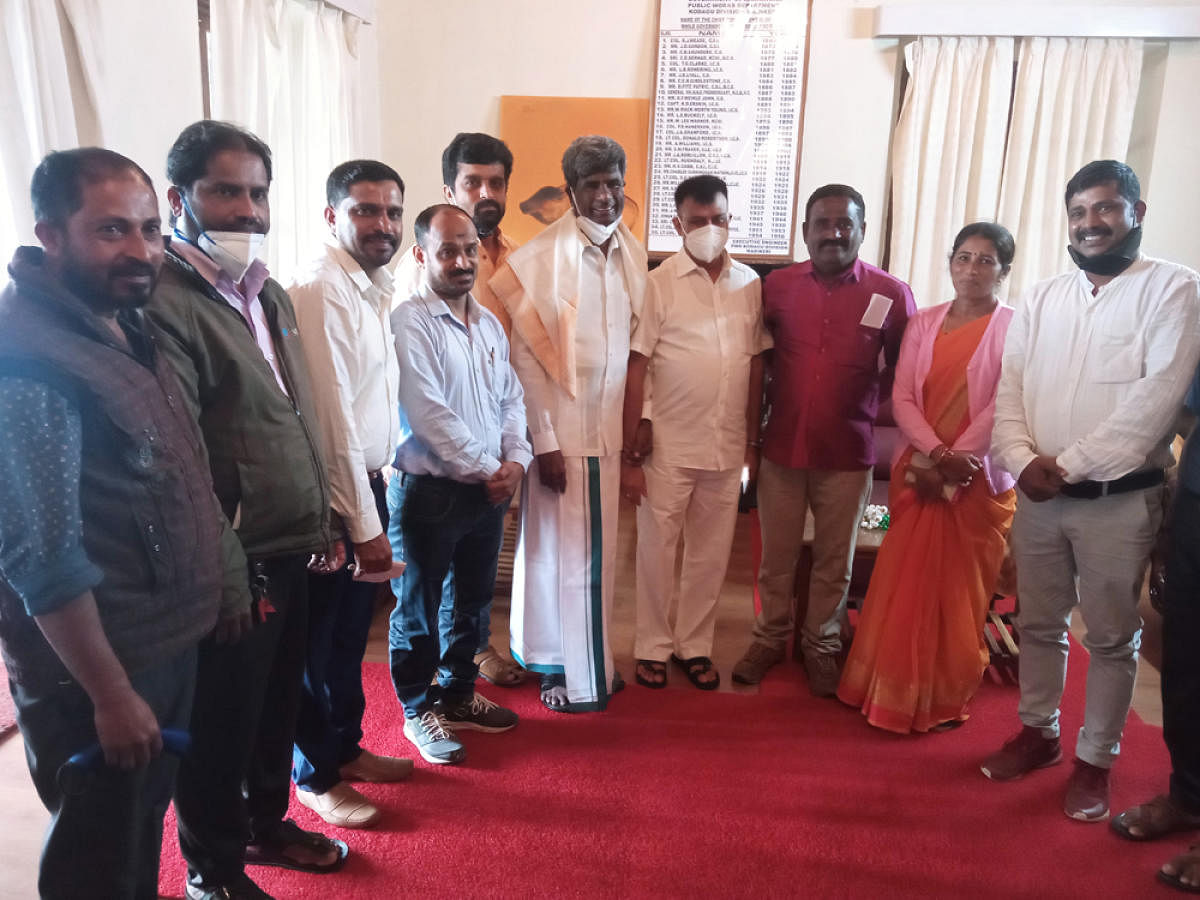 Residents of Thatibaane paisari with Minister Kota Srinivas Poojary in Madikeri.