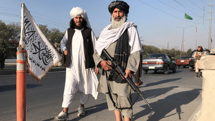 Taliban fighters stand outside the Interior Ministry in Kabul, Afghanistan. Credit: Reuters Photo