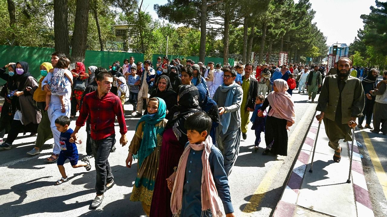 Afghan people move towards the Kabul airport to leave Kabul. Credit: AFP Photo