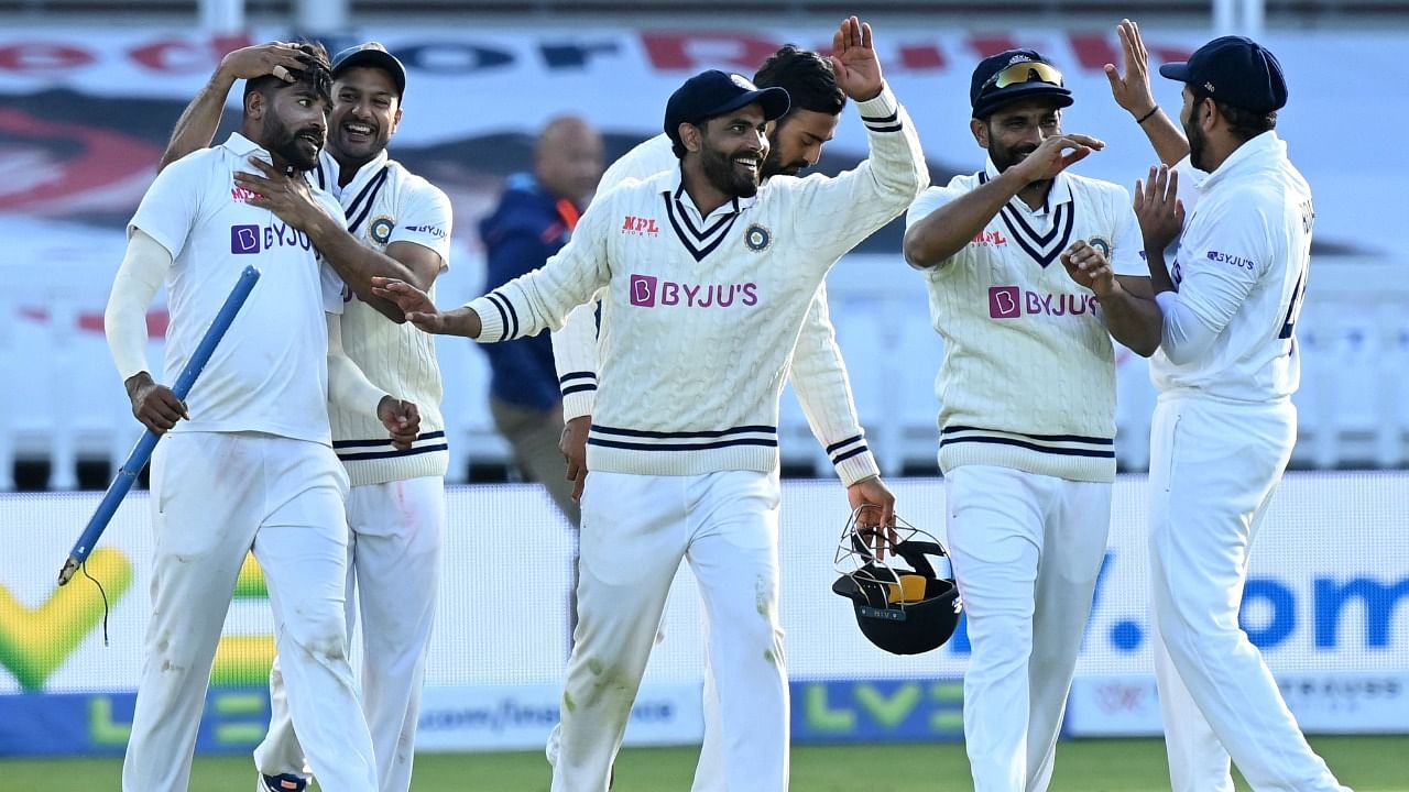 Mohammed Siraj (L) celebrates with his team mates after dismissing James Anderson to win the 2nd England Test. Credit: AFP Photo