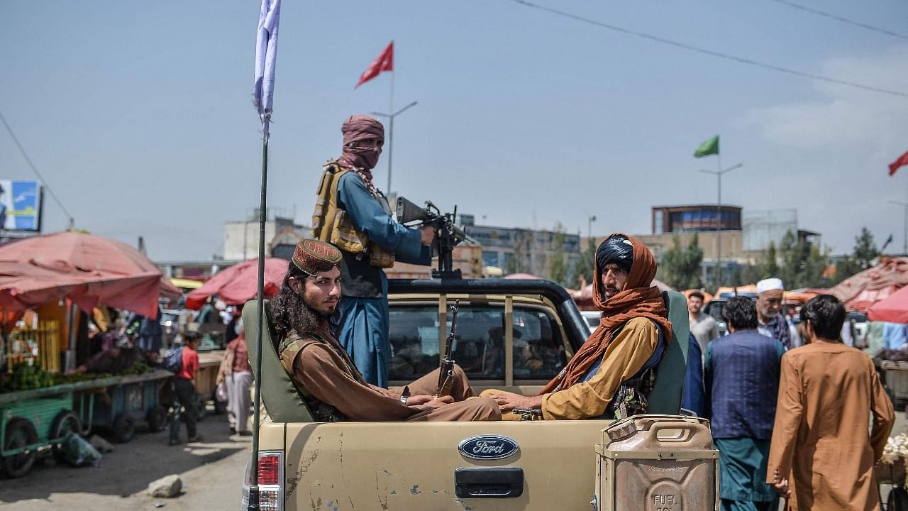 Taliban fighters on a pick-up truck. Credit: AFP Photo