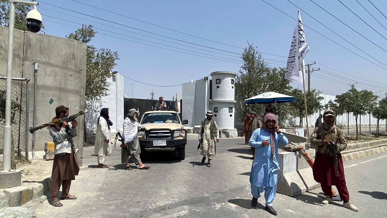 Taliban fighters stand guard. Credit: AFP Photo